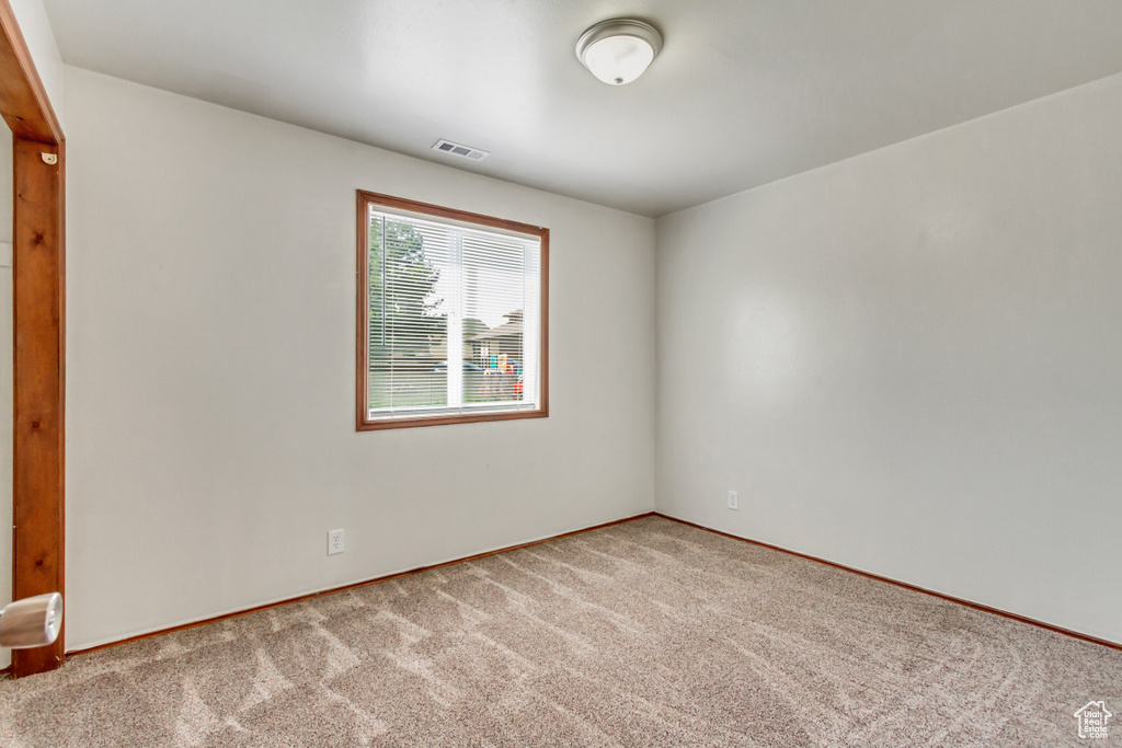 Empty room with light colored carpet