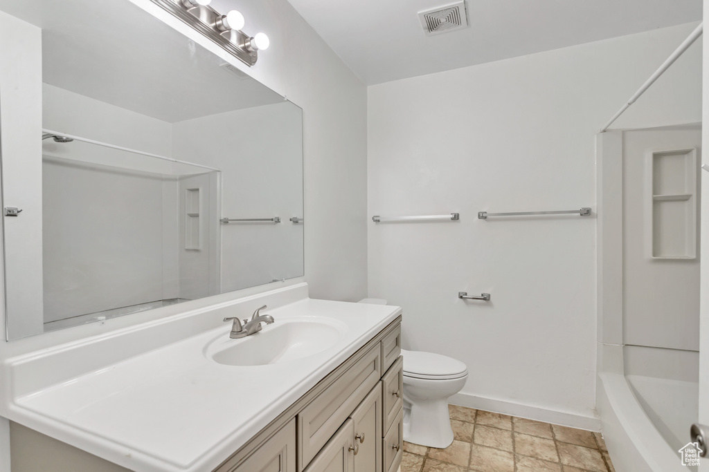 Full bathroom featuring tile flooring, shower / washtub combination, vanity, and toilet