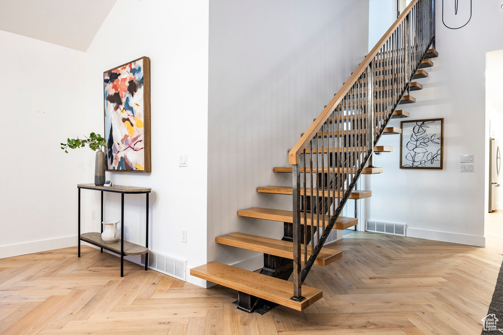 Staircase with light parquet flooring