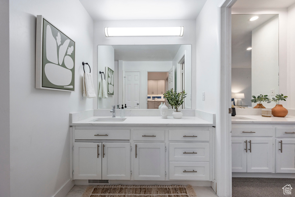 Bathroom featuring tile patterned flooring and vanity