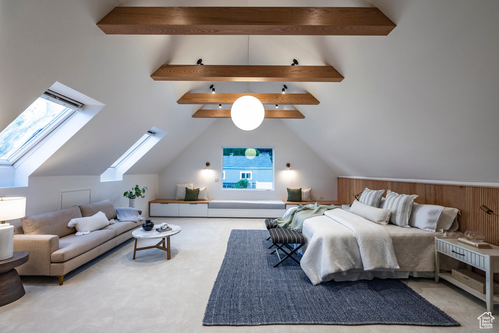 Carpeted bedroom featuring lofted ceiling with skylight