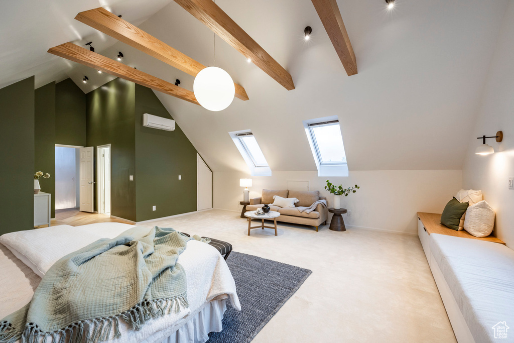 Bedroom with an AC wall unit, carpet, a skylight, and high vaulted ceiling