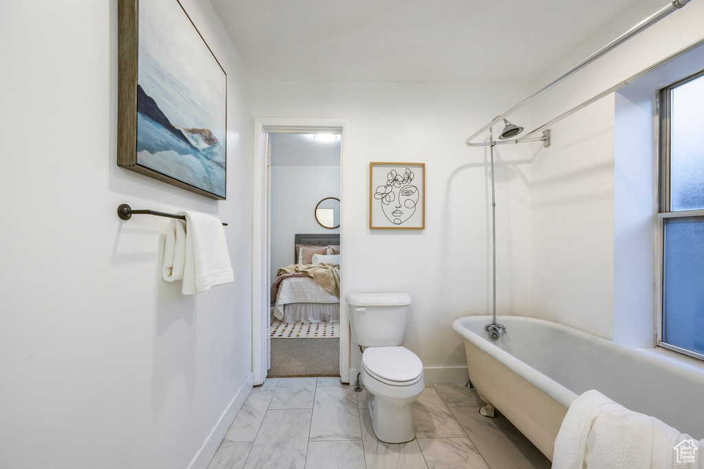 Bathroom with tile patterned flooring and toilet