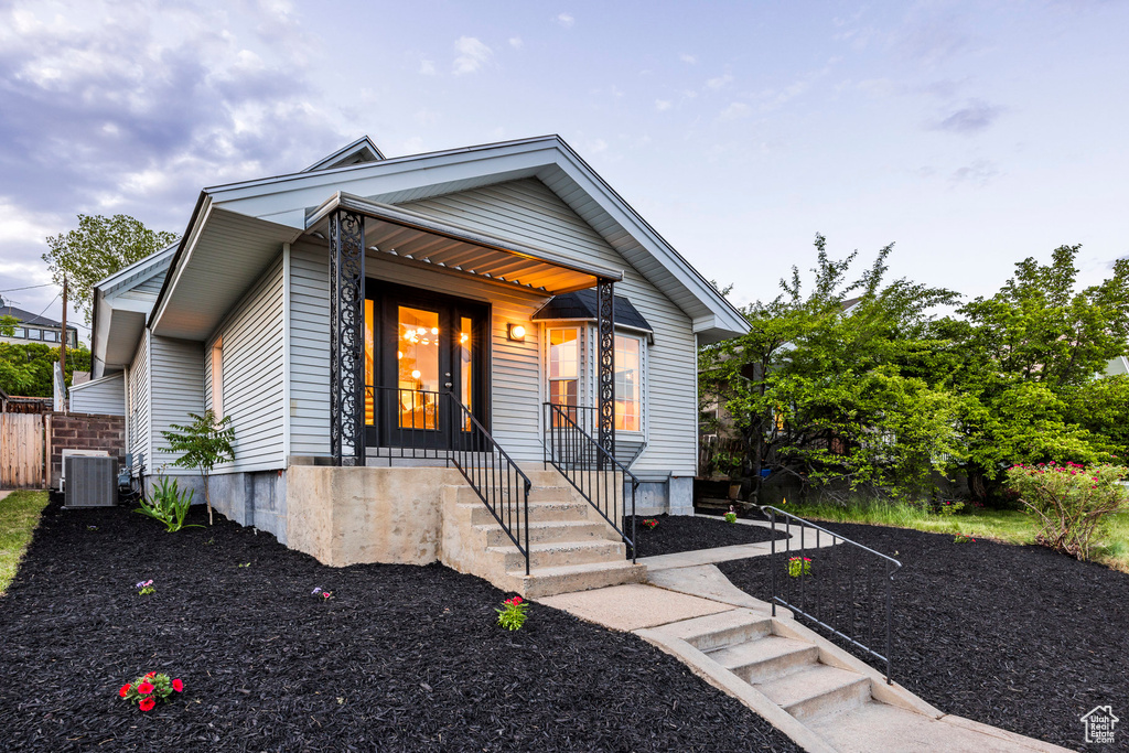 Bungalow featuring central AC and covered porch