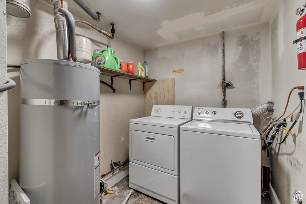 Washroom featuring washer and clothes dryer and gas water heater