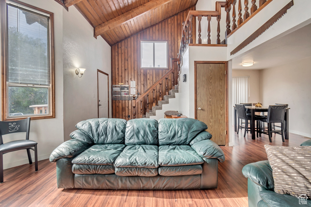 Living room with high vaulted ceiling, hardwood / wood-style flooring, and wood ceiling