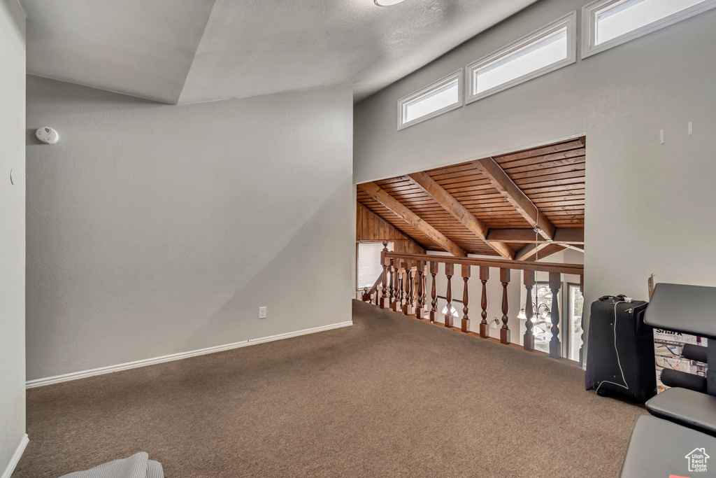 Interior space featuring beam ceiling and carpet