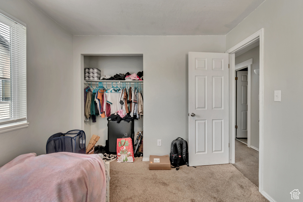 Carpeted bedroom with a closet