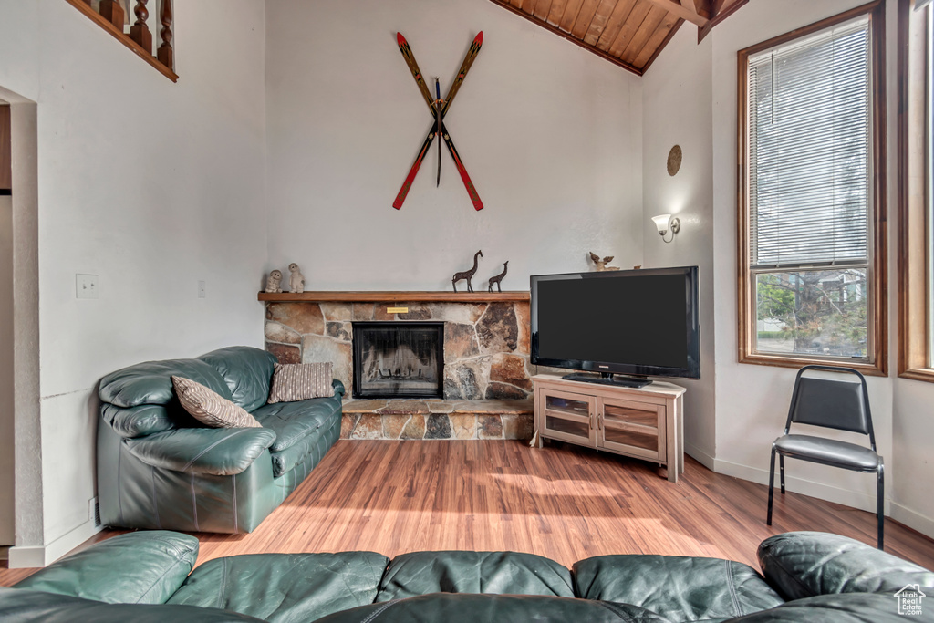 Living room with wood ceiling, a fireplace, wood-type flooring, and vaulted ceiling