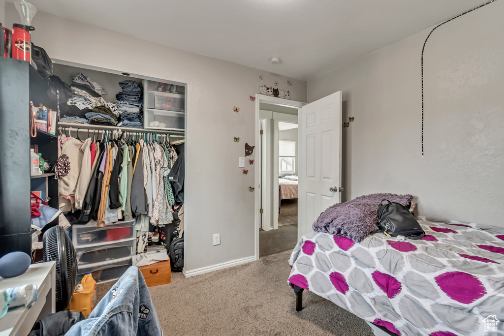 Bedroom with carpet and a closet