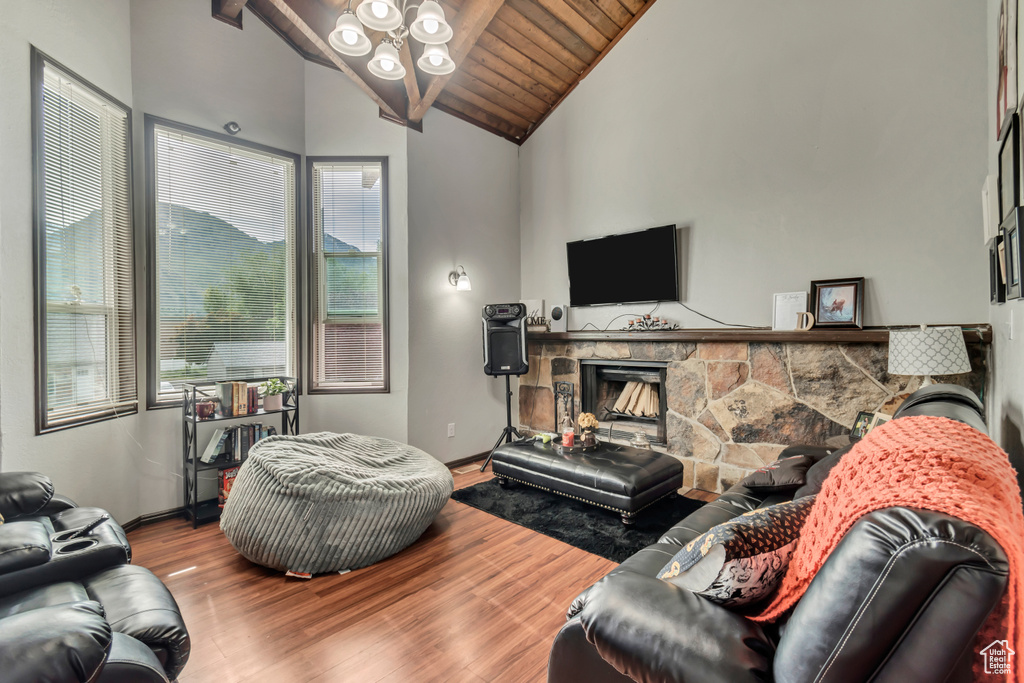 Living room with hardwood / wood-style floors, plenty of natural light, a fireplace, and wood ceiling