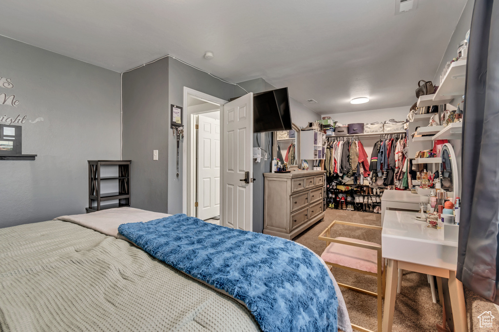 Carpeted bedroom with a closet