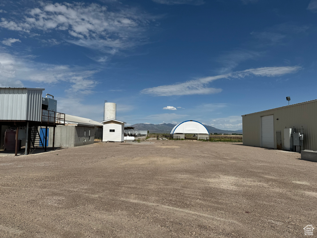 View of yard featuring an outdoor structure and a mountain view