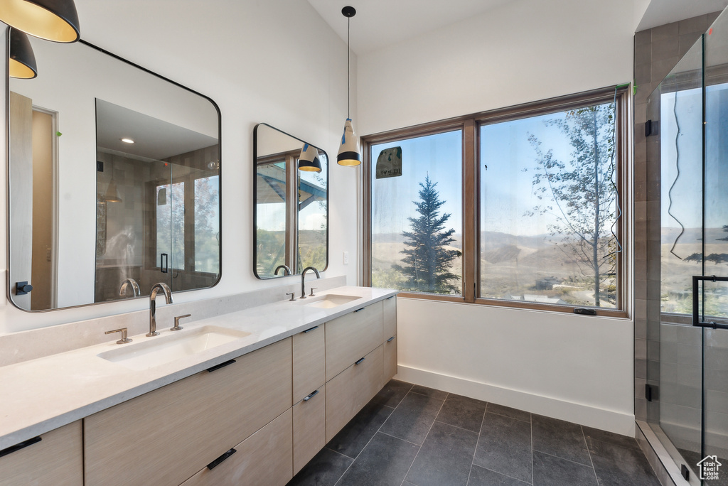 Bathroom featuring vanity, an enclosed shower, and tile patterned floors