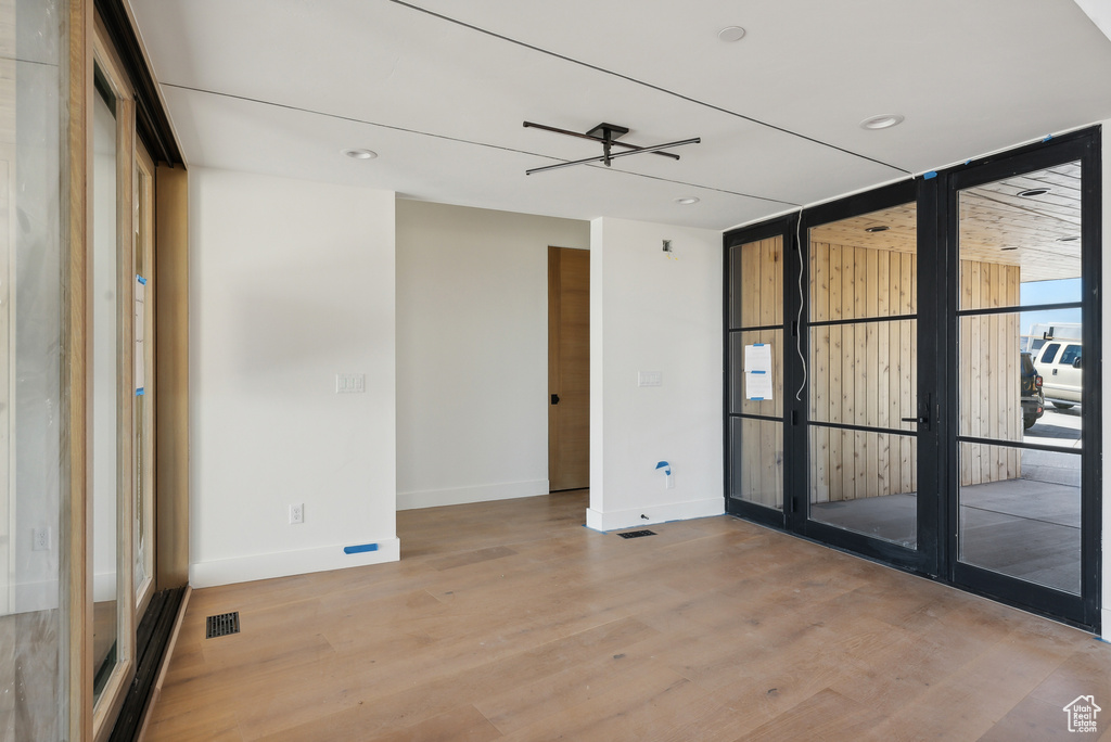 Empty room featuring light hardwood / wood-style flooring and ceiling fan