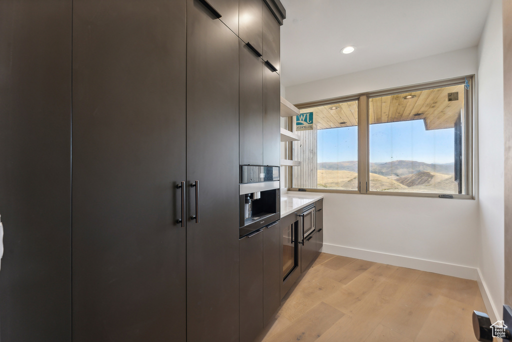 Kitchen with light hardwood / wood-style floors and a mountain view