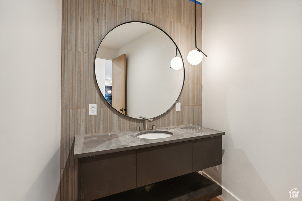 Bathroom with vanity and tile walls