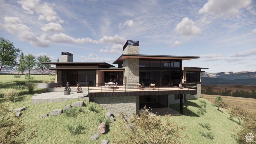 Rear view of property with a patio, a mountain view, and a yard