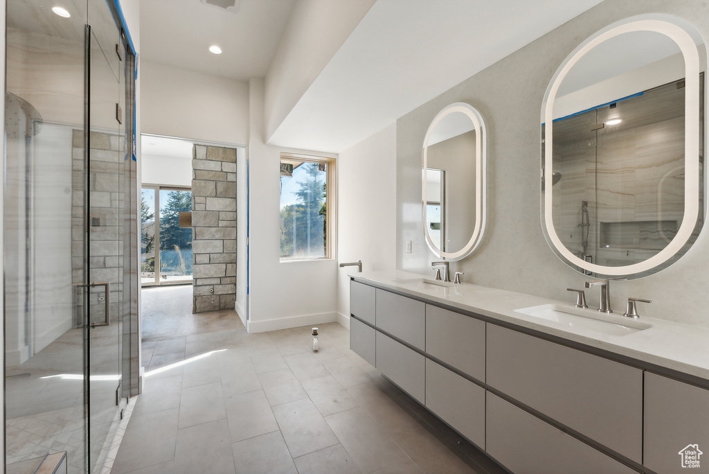 Bathroom featuring vanity and an enclosed shower