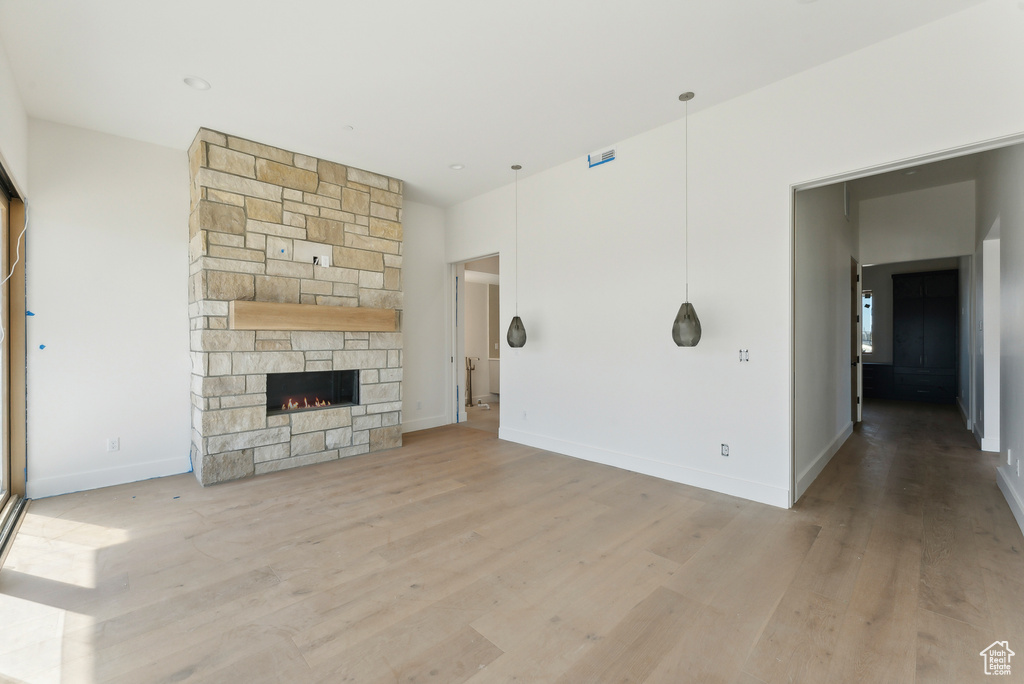 Unfurnished living room featuring light hardwood / wood-style floors and a fireplace