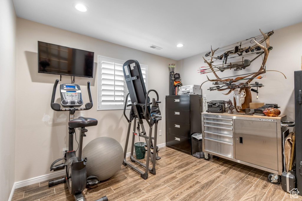 Exercise room featuring light hardwood / wood-style floors