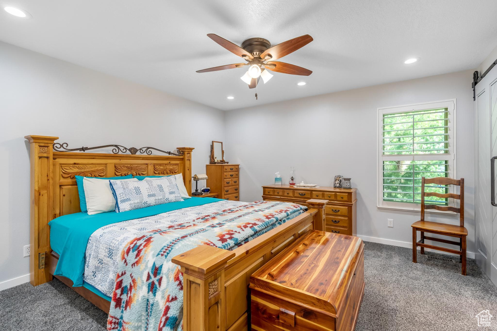 Bedroom featuring dark carpet and ceiling fan