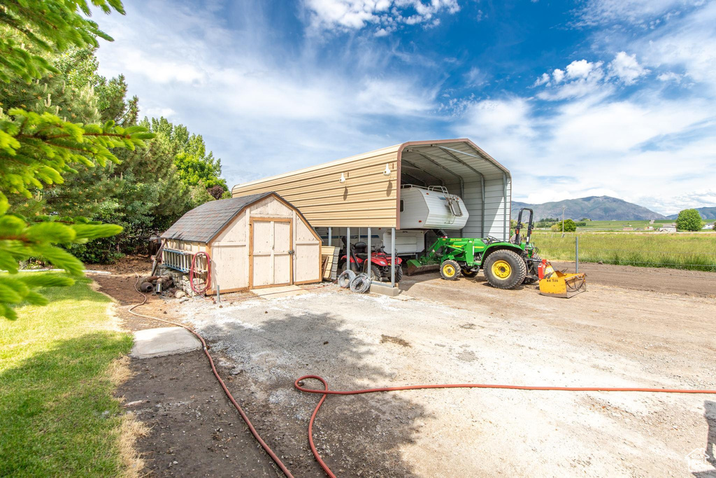 View of outdoor structure featuring a carport and a mountain view