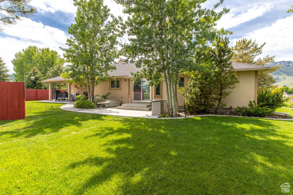 Rear view of house with a lawn