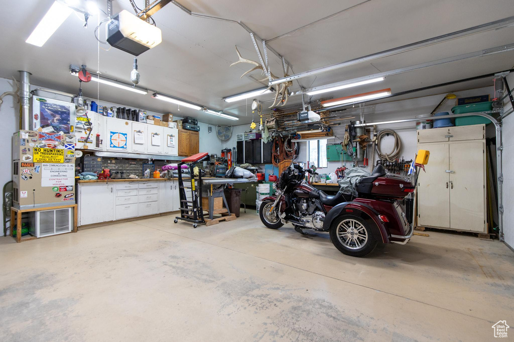 Garage with a workshop area and a garage door opener