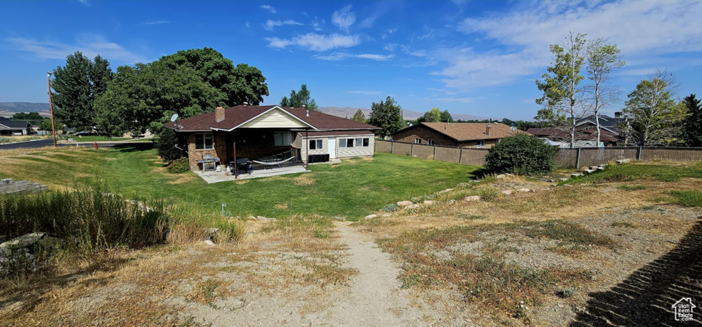 Back of house featuring a patio and a yard