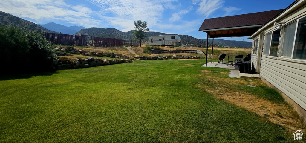 View of yard with a patio and a mountain view