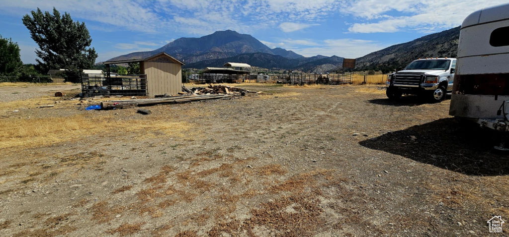 View of yard with a mountain view and an outdoor structure