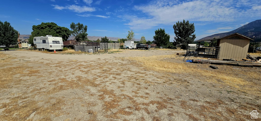 View of yard featuring a mountain view and a shed