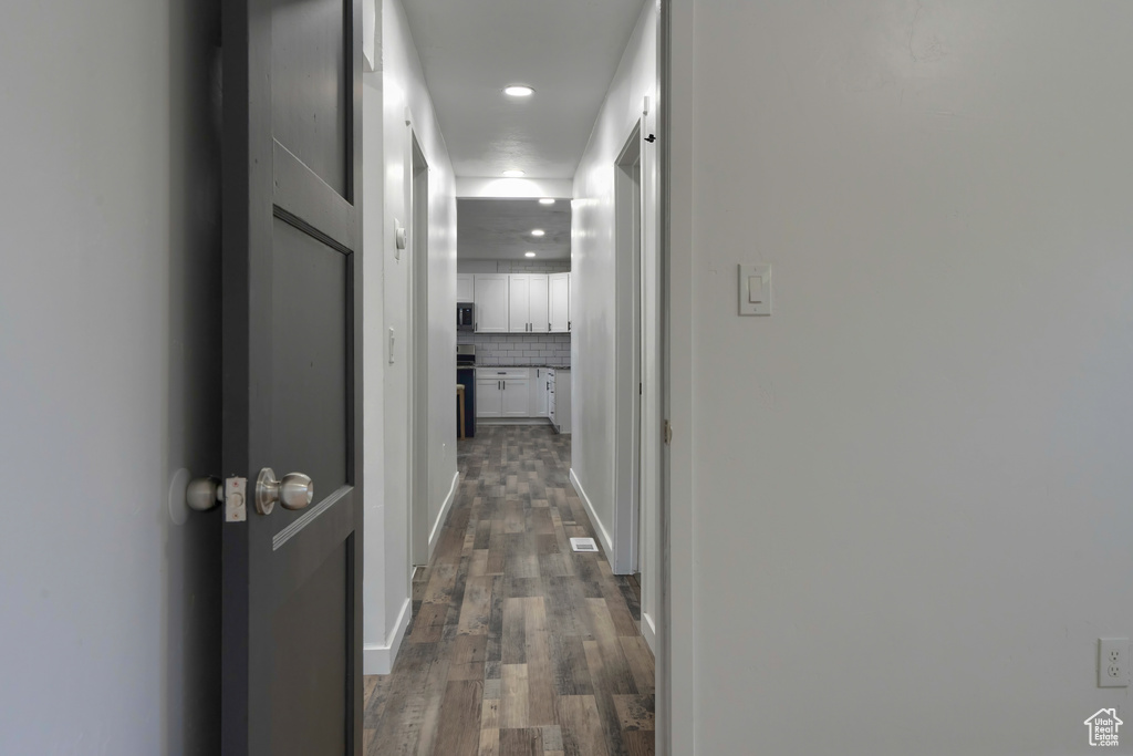 Hall with dark hardwood / wood-style flooring