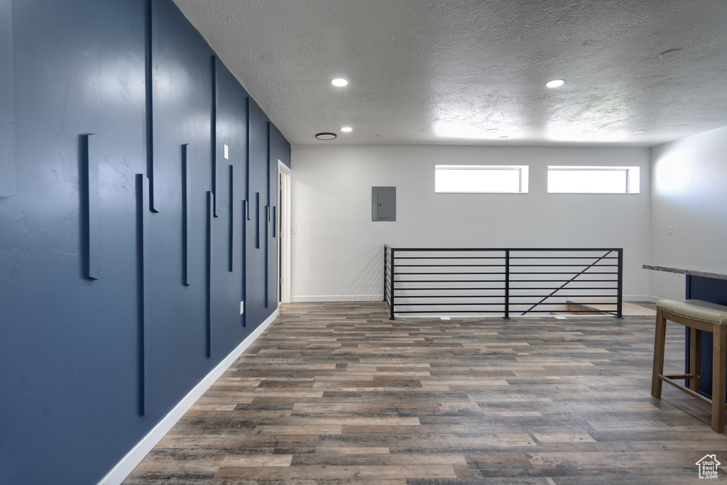 Interior space with dark hardwood / wood-style floors and a textured ceiling