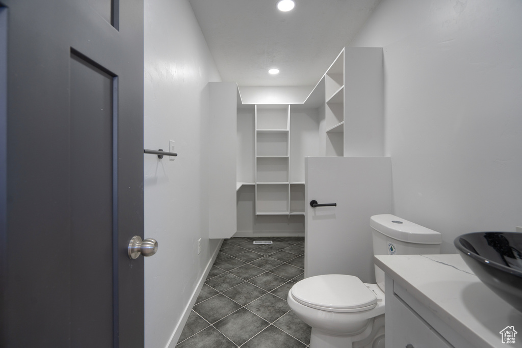 Bathroom featuring tile flooring, toilet, and vanity