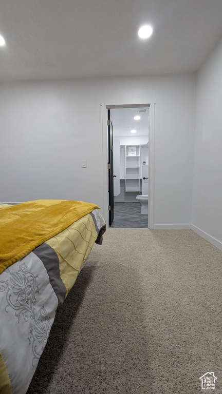 Bedroom featuring a spacious closet and carpet