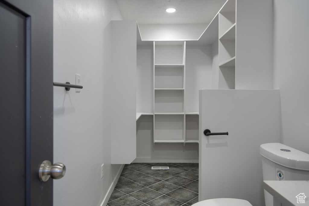 Bathroom featuring tile flooring and toilet