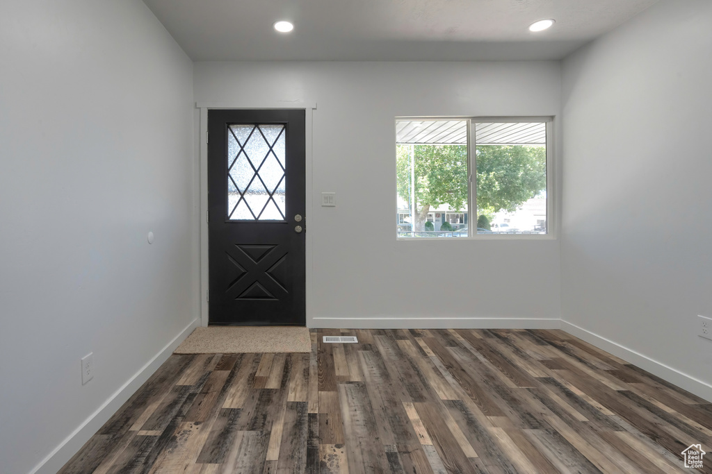 Foyer entrance with dark wood-type flooring