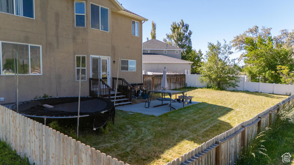 View of yard featuring a patio area and a trampoline