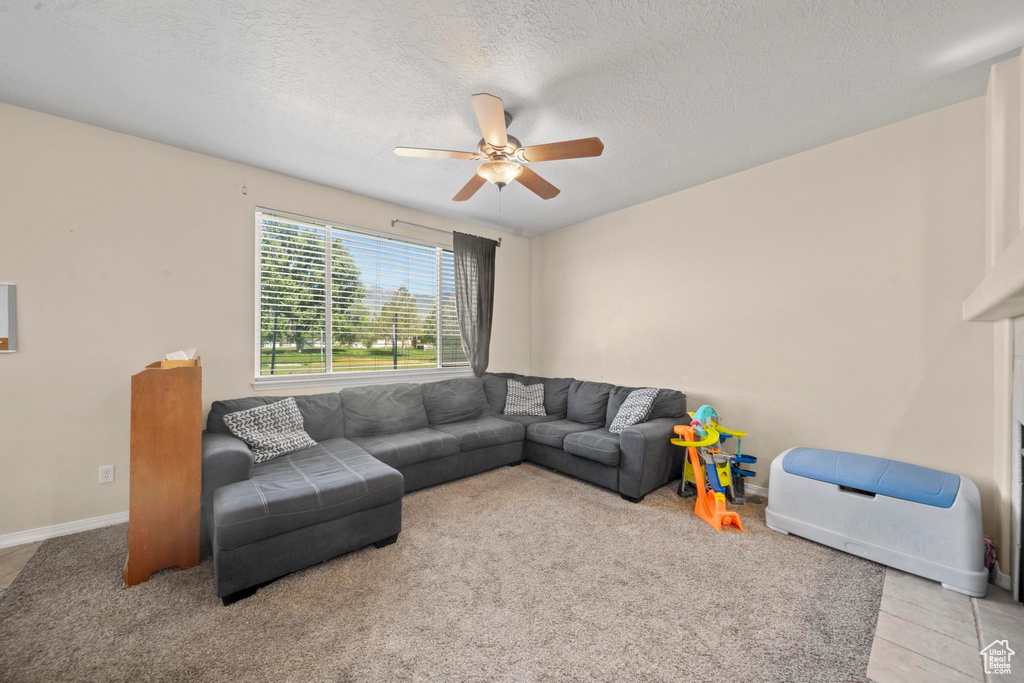 Living room with a textured ceiling and ceiling fan