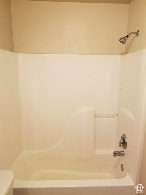 Bathroom with shower / bathtub combination and toilet