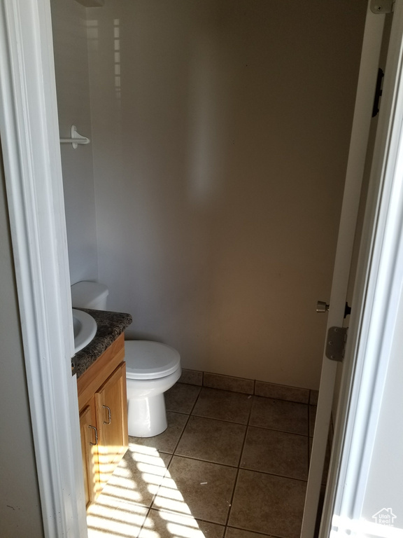 Bathroom featuring tile flooring, toilet, and vanity