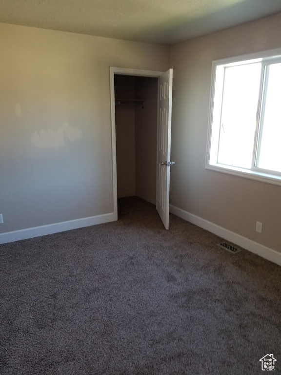 Interior space with carpet flooring and a closet