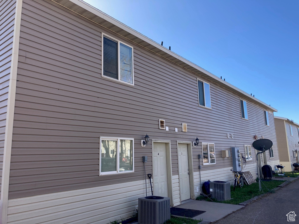 Rear view of house with central AC