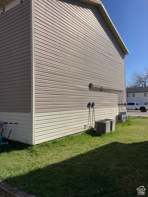 View of side of home with a yard