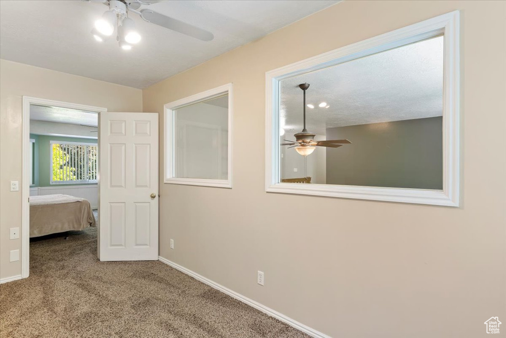 Unfurnished bedroom with carpet flooring and ceiling fan