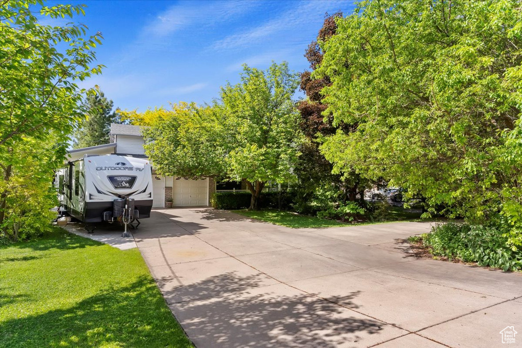 Exterior space featuring a garage and a front yard