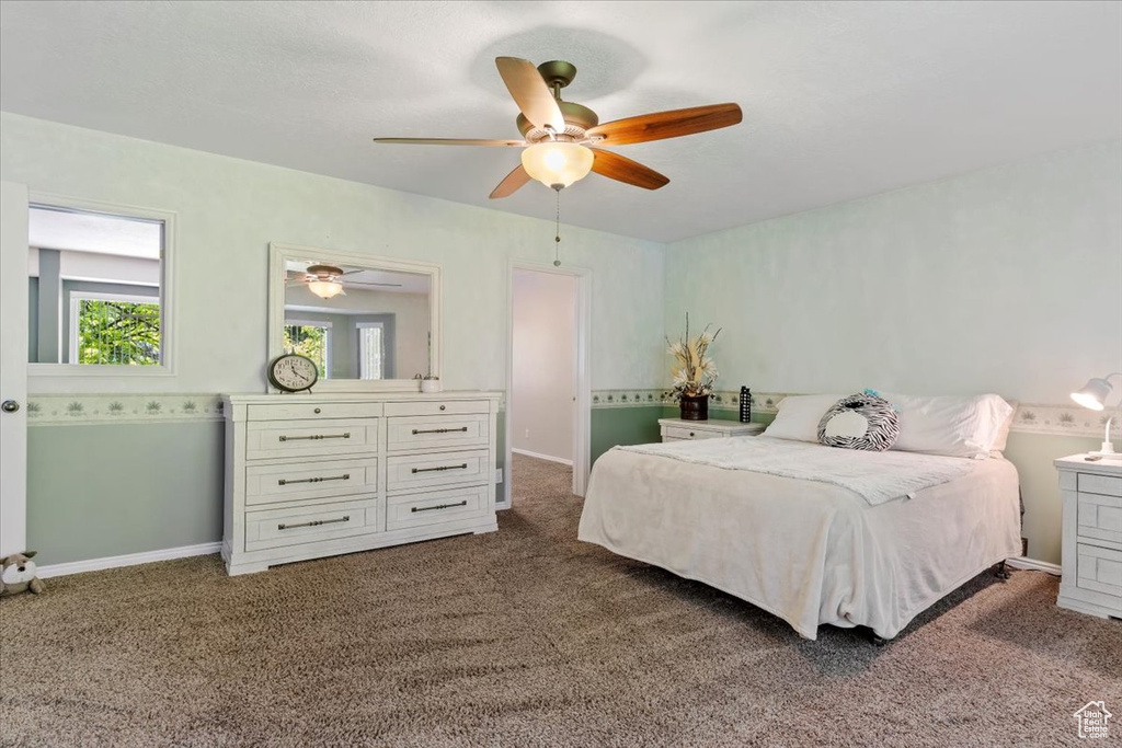 Bedroom featuring dark colored carpet and ceiling fan