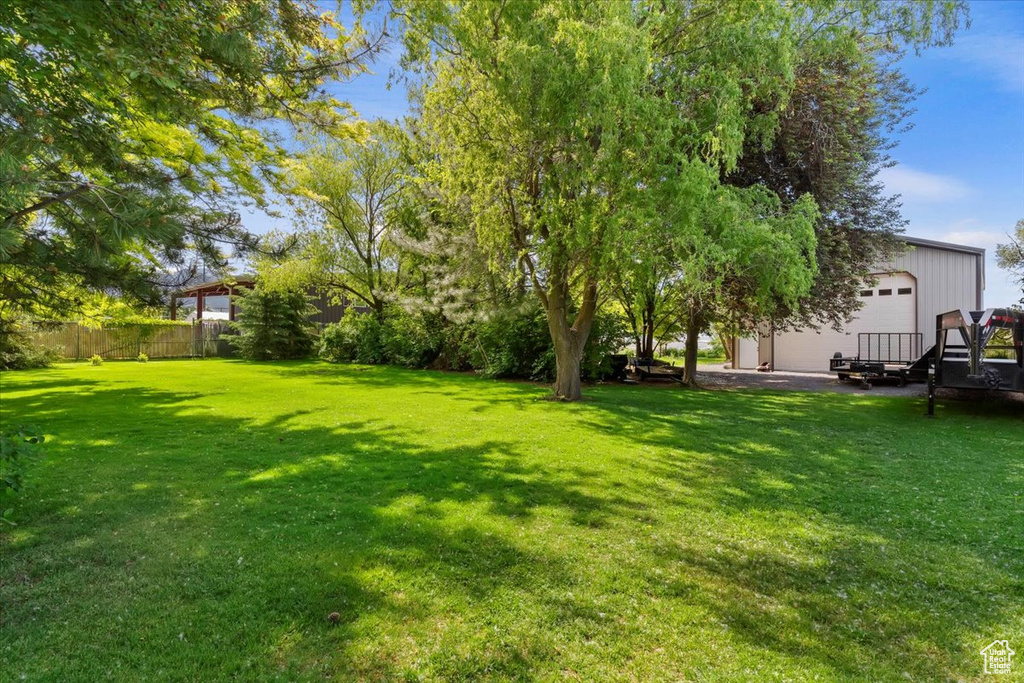 View of yard featuring a garage and an outdoor structure